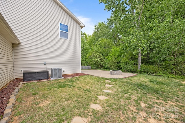view of yard with cooling unit, a patio area, and an outdoor fire pit