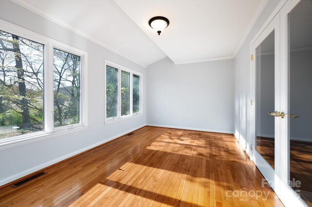 501 Crowfields Ln, Asheville, NC 28803 - empty room with visible vents, baseboards, hardwood / wood-style flooring, and lofted ceiling
