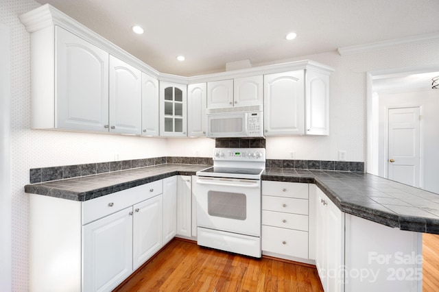 501 Crowfields Ln, Asheville, NC 28803 - kitchen featuring ornamental molding, white appliances, a peninsula, white cabinets, and light wood-style floors