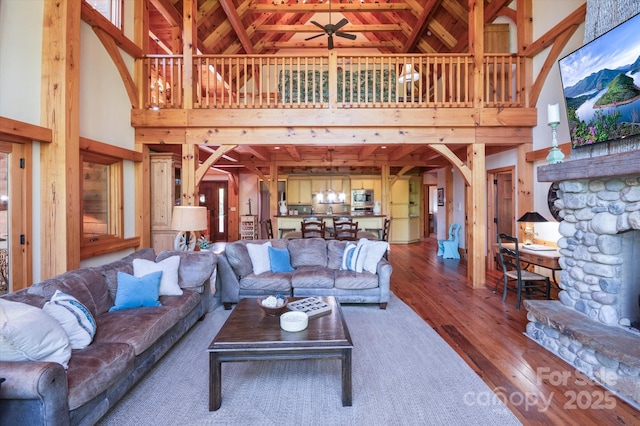 54 Cottage Grove Dr, Nebo, NC 28761 - living area with a fireplace, arched walkways, high vaulted ceiling, ceiling fan with notable chandelier, and hardwood / wood-style floors