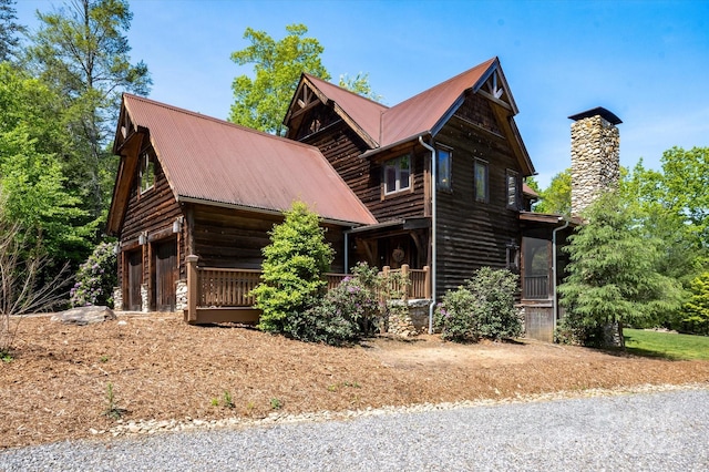 54 Cottage Grove Dr, Nebo, NC 28761 - view of front facade with a porch, a garage, a chimney, and metal roof
