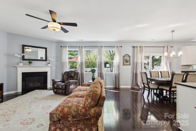 221 Sycamore Creek Rd, Fort Mill, SC 29708 - living room with a glass covered fireplace, a healthy amount of sunlight, baseboards, and dark wood-style floors
