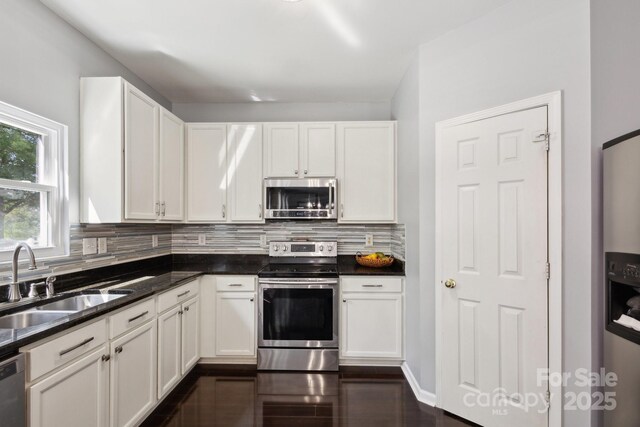221 Sycamore Creek Rd, Fort Mill, SC 29708 - kitchen featuring white cabinets, a sink, backsplash, and appliances with stainless steel finishes