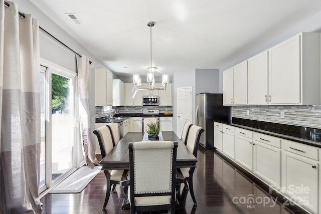 221 Sycamore Creek Rd, Fort Mill, SC 29708 - kitchen with dark countertops, tasteful backsplash, dark wood-style flooring, and appliances with stainless steel finishes