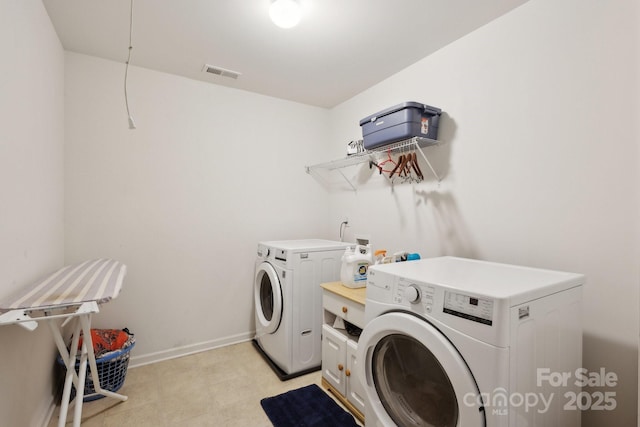 221 Sycamore Creek Rd, Fort Mill, SC 29708 - laundry area with light floors, separate washer and dryer, visible vents, baseboards, and cabinet space