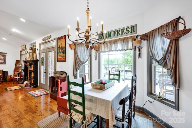 dining room featuring wood finished floors, a chandelier, french doors, and recessed lighting