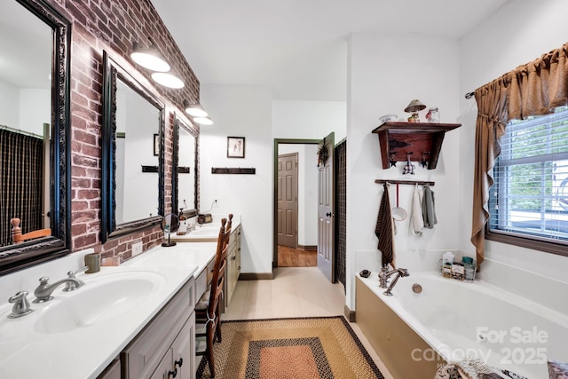 bathroom featuring double vanity, a bath, tile patterned flooring, and a sink