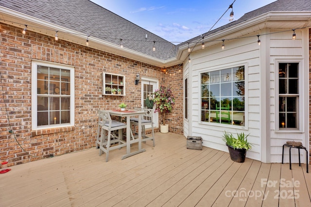 wooden deck featuring outdoor dining area