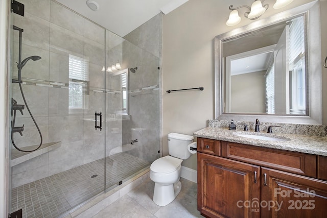 bathroom with a stall shower, a healthy amount of sunlight, toilet, tile patterned flooring, and vanity