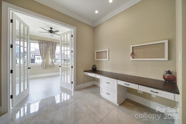 unfurnished office with built in study area, ceiling fan, french doors, baseboards, and ornamental molding