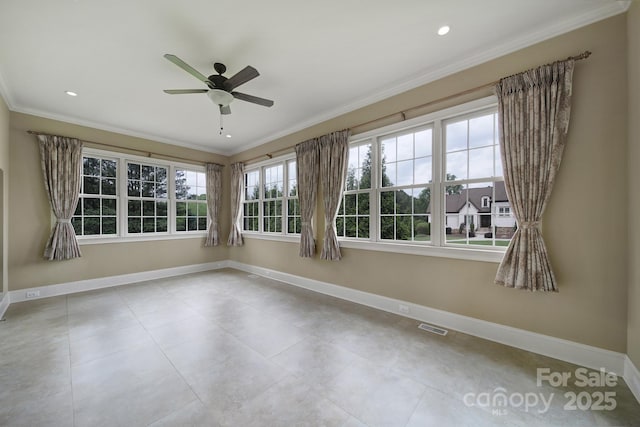tiled empty room with baseboards, a ceiling fan, visible vents, and crown molding