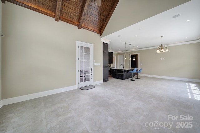 living room featuring baseboards, recessed lighting, a notable chandelier, beamed ceiling, and wooden ceiling