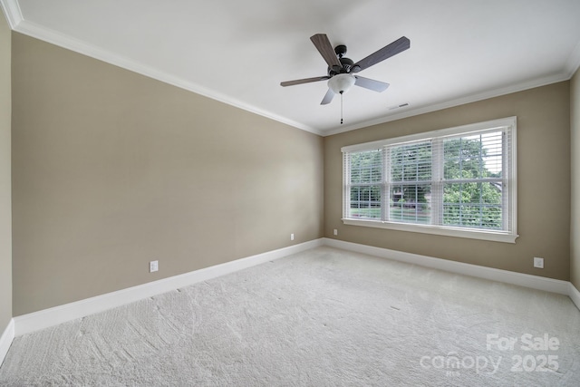 empty room with ornamental molding, visible vents, light colored carpet, and baseboards