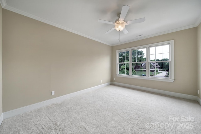 spare room featuring visible vents, baseboards, carpet, ceiling fan, and ornamental molding