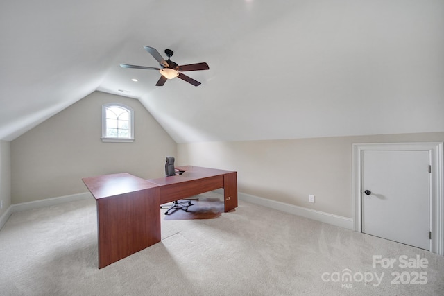 carpeted home office featuring ceiling fan, vaulted ceiling, and baseboards