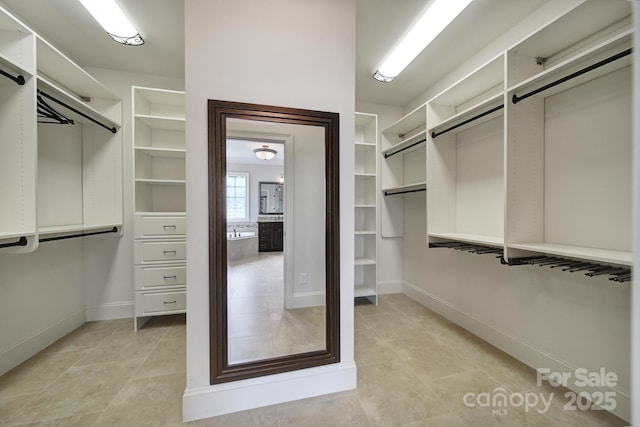 spacious closet featuring light tile patterned floors