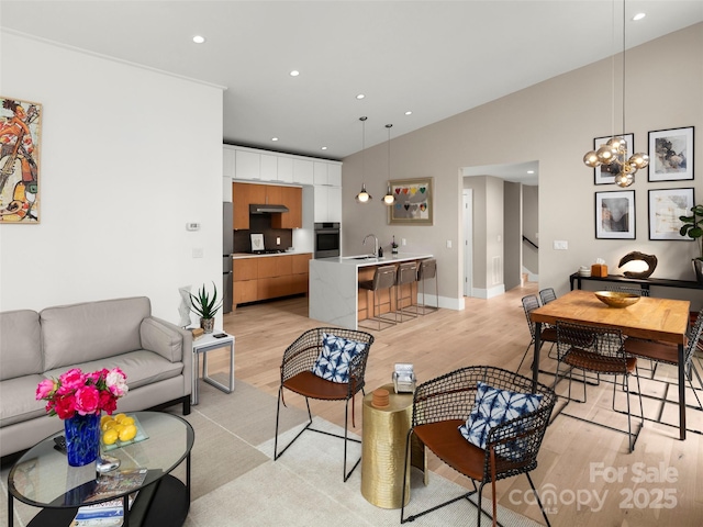146 Timber Creek Rd, Hendersonville, NC 28739 - living room with light wood-type flooring, vaulted ceiling, stairway, recessed lighting, and baseboards