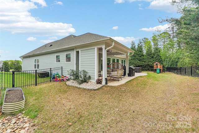 back of house with a fenced backyard, a patio, a playground, and a lawn