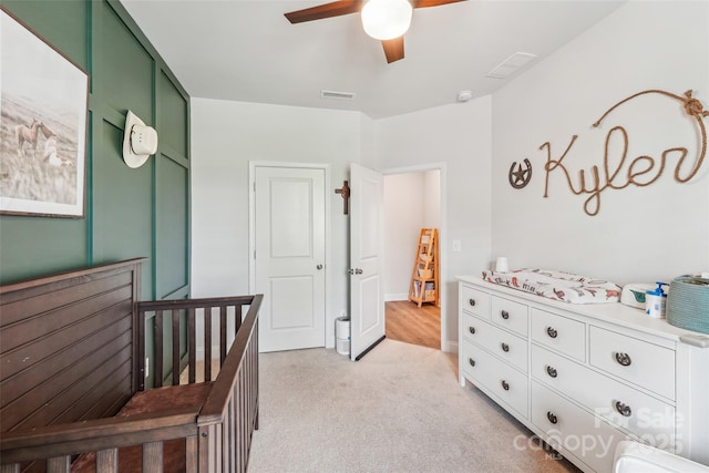 bedroom featuring visible vents, a ceiling fan, and light colored carpet