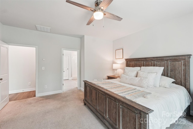 bedroom with baseboards, visible vents, a ceiling fan, and light colored carpet