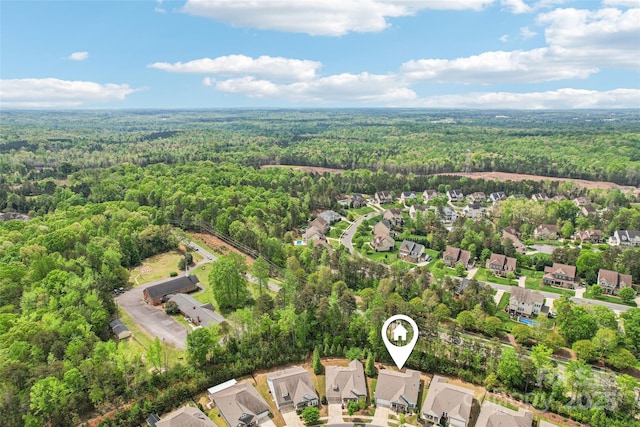 bird's eye view with a forest view and a residential view