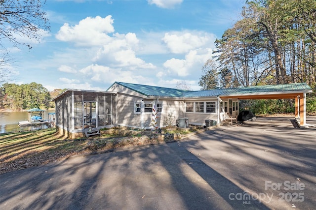 6778 Emerald Isle Dr, Sherrills Ford, NC 28673 - view of front of house featuring driveway, a sunroom, an attached carport, and a metal roof