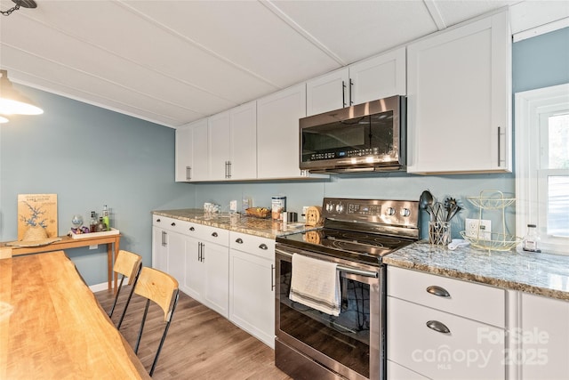 6778 Emerald Isle Dr, Sherrills Ford, NC 28673 - kitchen with stainless steel appliances, white cabinets, light wood-style floors, and light stone countertops
