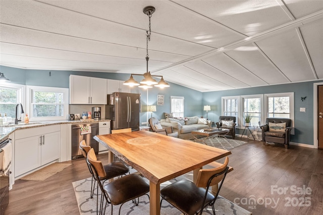 6778 Emerald Isle Dr, Sherrills Ford, NC 28673 - dining area with wood finished floors, lofted ceiling, and plenty of natural light