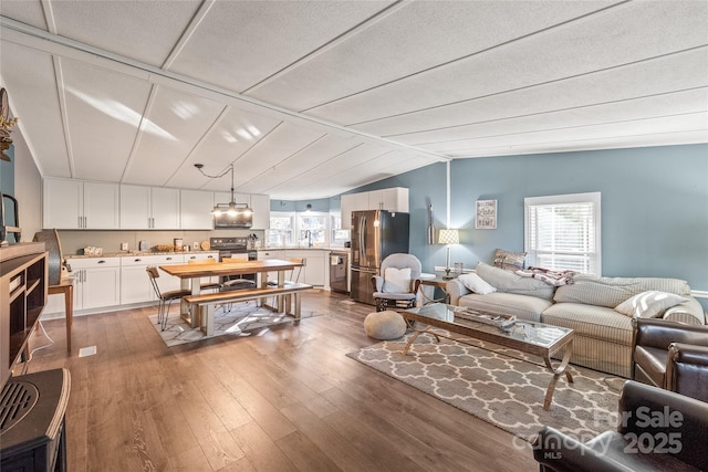 6778 Emerald Isle Dr, Sherrills Ford, NC 28673 - living room featuring healthy amount of natural light, wood-type flooring, and vaulted ceiling