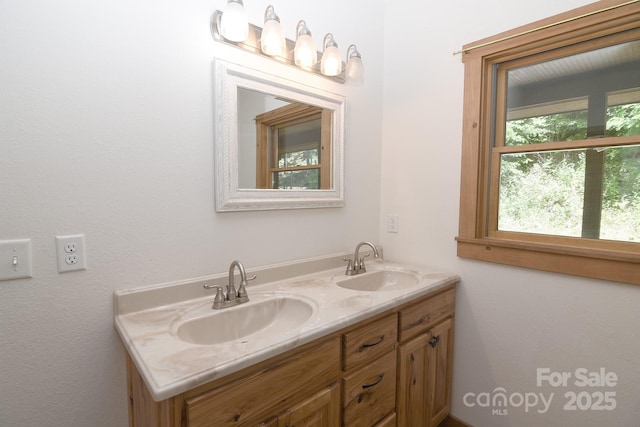 bathroom featuring a sink and double vanity