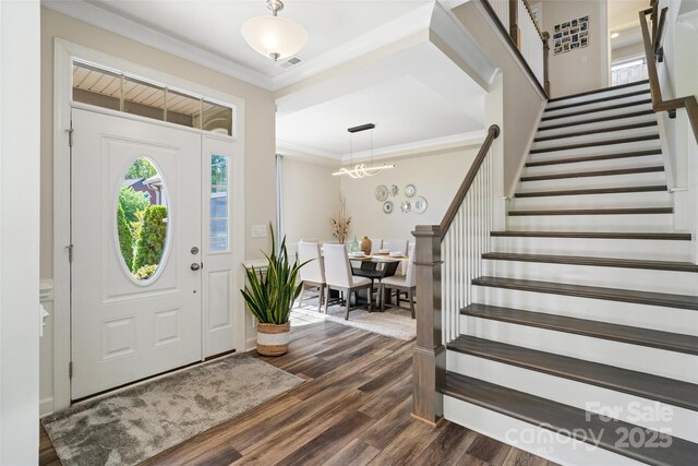 513 Sandbar Pt, Lake Wylie, SC 29710 - entrance foyer featuring dark wood-style flooring, ornamental molding, stairway, and visible vents