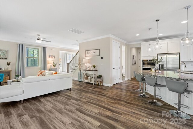 513 Sandbar Pt, Lake Wylie, SC 29710 - living room featuring crown molding, a ceiling fan, recessed lighting, stairway, and dark wood-style floors