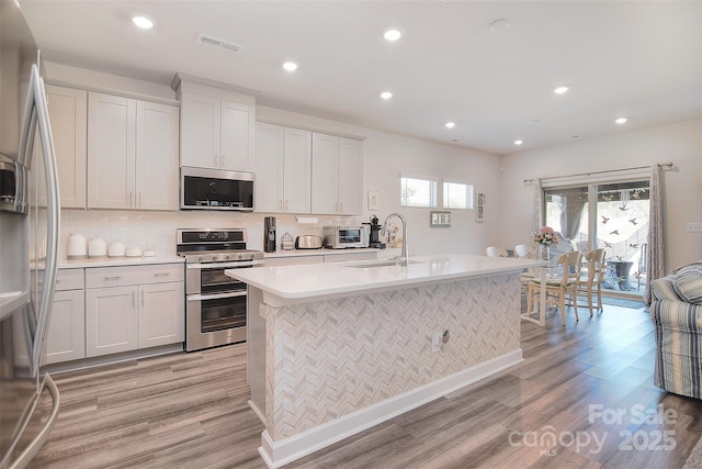 11616 Solstice Way, Huntersville, NC 28078 - kitchen featuring a sink, visible vents, stainless steel appliances, light countertops, and light wood finished floors