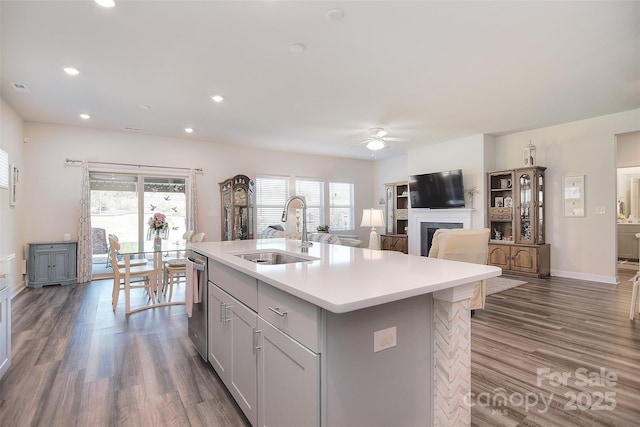 11616 Solstice Way, Huntersville, NC 28078 - kitchen featuring a sink, light countertops, dark wood finished floors, a fireplace, and a ceiling fan