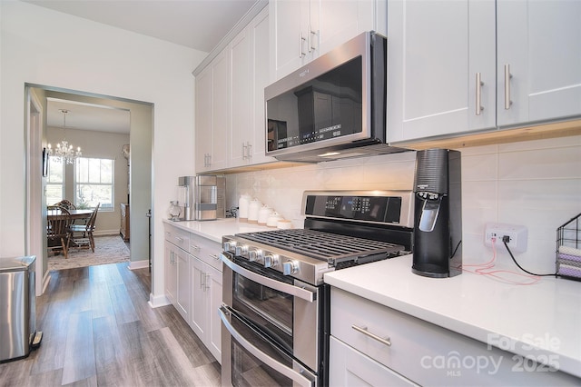 11616 Solstice Way, Huntersville, NC 28078 - kitchen featuring an inviting chandelier, decorative backsplash, stainless steel appliances, and light countertops