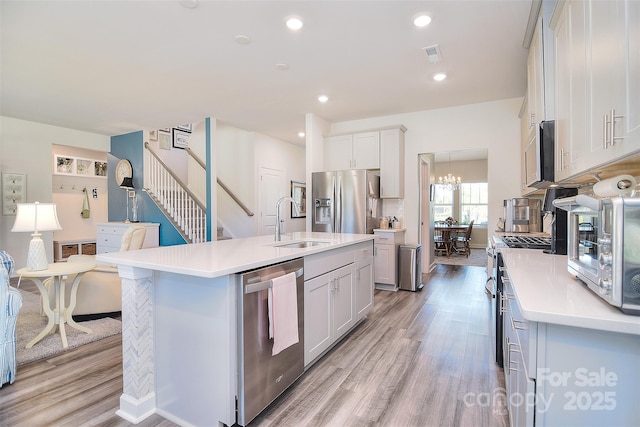 11616 Solstice Way, Huntersville, NC 28078 - kitchen with a sink, appliances with stainless steel finishes, light wood-style floors, visible vents, and light countertops