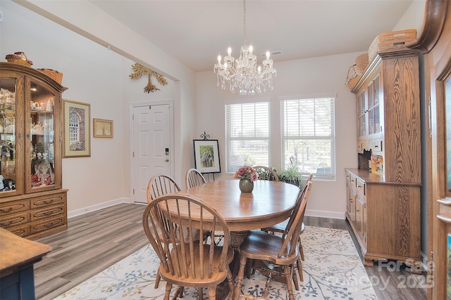 11616 Solstice Way, Huntersville, NC 28078 - dining area featuring wood finished floors, a notable chandelier, and baseboards