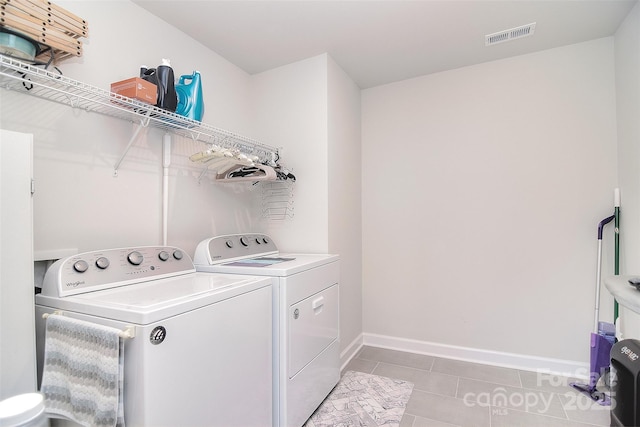 11616 Solstice Way, Huntersville, NC 28078 - clothes washing area with visible vents, baseboards, light tile patterned flooring, separate washer and dryer, and laundry area