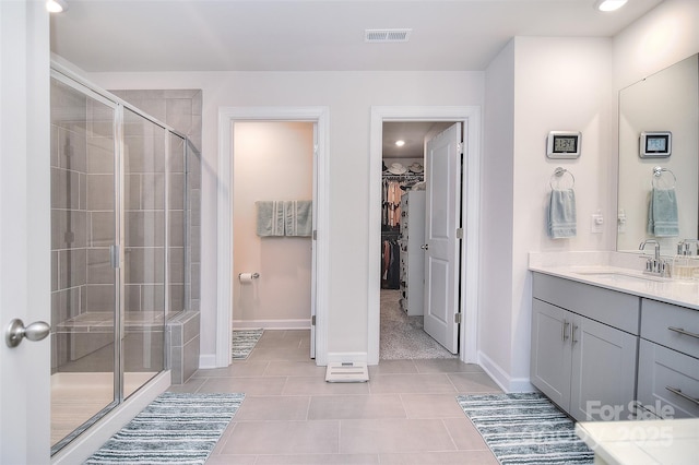 11616 Solstice Way, Huntersville, NC 28078 - full bathroom with a shower stall, vanity, tile patterned floors, a walk in closet, and visible vents