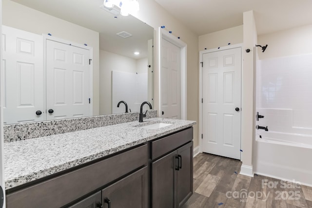 4149 River Run Cir, Hickory, NC 28602 - bathroom featuring vanity, baseboards, bathing tub / shower combination, visible vents, and wood finished floors