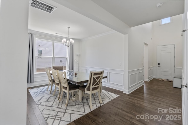 184 Tetcott St, Mooresville, NC 28115 - dining area with wainscoting, wood finished floors, visible vents, and a notable chandelier