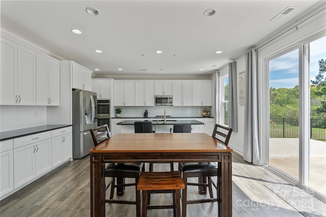 184 Tetcott St, Mooresville, NC 28115 - kitchen with wood finished floors, stainless steel appliances, recessed lighting, and white cabinetry