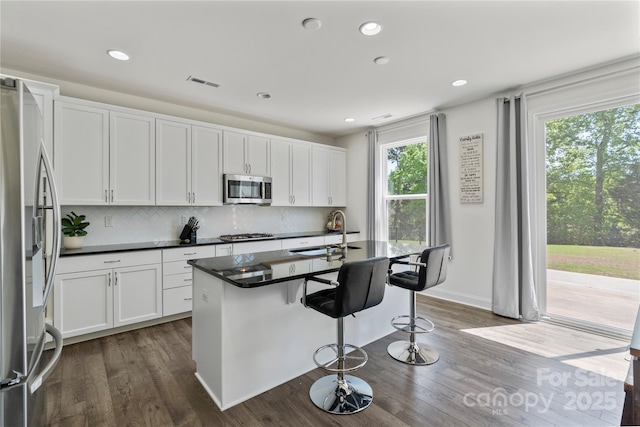 184 Tetcott St, Mooresville, NC 28115 - kitchen featuring dark countertops, a sink, appliances with stainless steel finishes, dark wood-type flooring, and visible vents