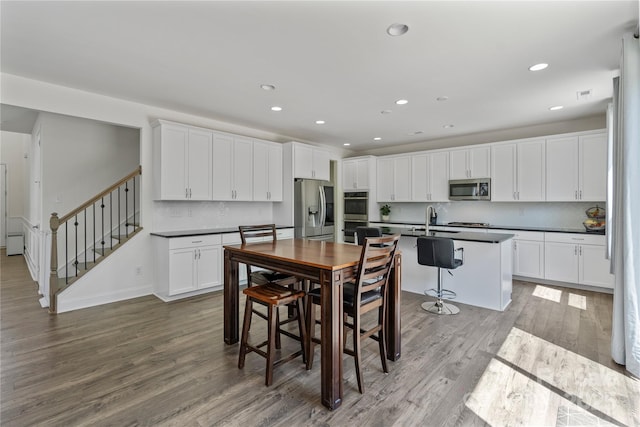 184 Tetcott St, Mooresville, NC 28115 - dining room with visible vents, wood finished floors, recessed lighting, and stairs