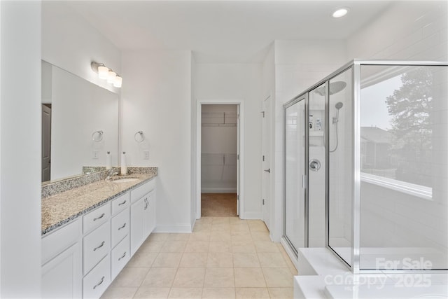 184 Tetcott St, Mooresville, NC 28115 - full bath with tile patterned floors, a shower stall, vanity, baseboards, and a spacious closet