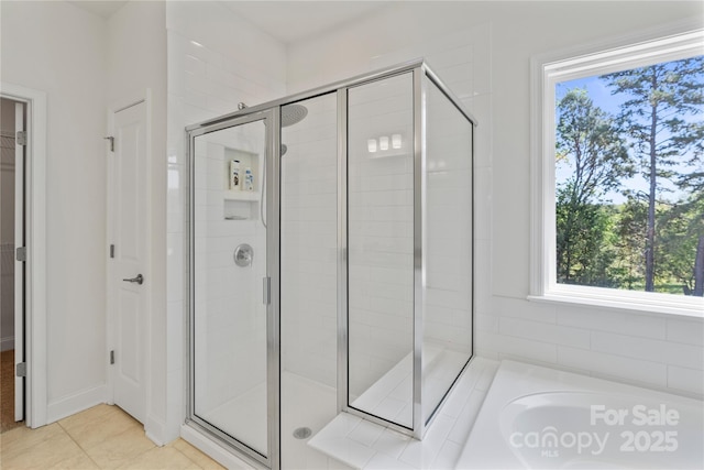 184 Tetcott St, Mooresville, NC 28115 - full bathroom featuring a shower stall, a washtub, a walk in closet, and tile patterned flooring