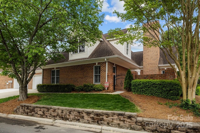 7502 Hurstbourne Green Dr, Charlotte, NC 28277 - view of front of house featuring roof with shingles, driveway, an attached garage, a front lawn, and brick siding