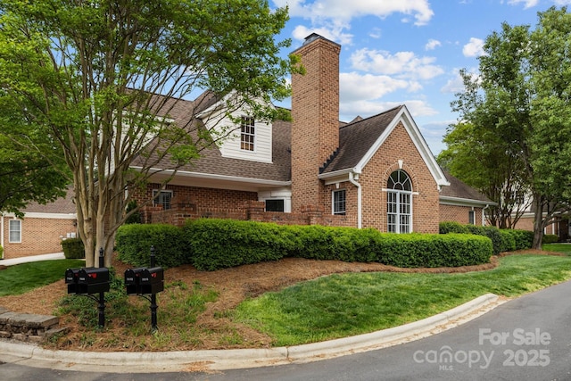 7502 Hurstbourne Green Dr, Charlotte, NC 28277 - view of front of house featuring roof with shingles, a chimney, a front lawn, and brick siding
