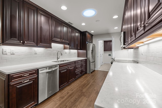 7502 Hurstbourne Green Dr, Charlotte, NC 28277 - kitchen featuring dark brown cabinetry, a sink, backsplash, and stainless steel appliances