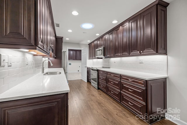 7502 Hurstbourne Green Dr, Charlotte, NC 28277 - kitchen with visible vents, a sink, backsplash, and appliances with stainless steel finishes